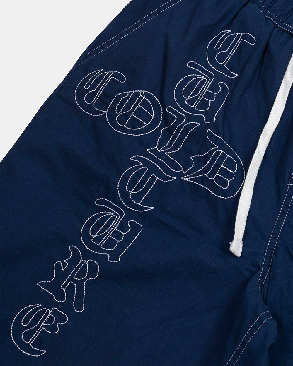CROSSED SWIMSHORTS BLUE - navy gothic print swim shorts, detail close-up - Cold Culture