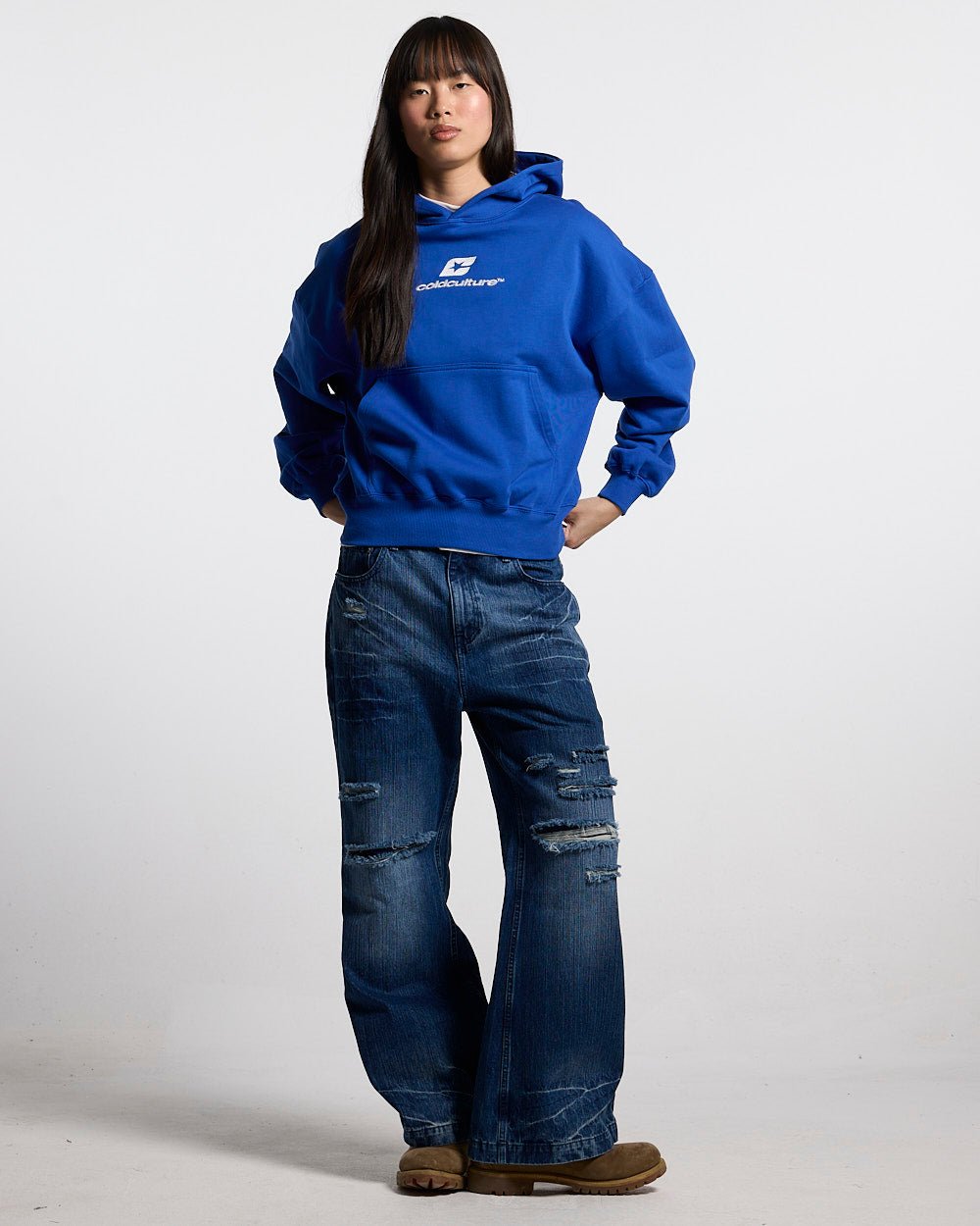 CURVED HOODIE BLUE - royal blue logo print hoodie, front view on female model - Cold Culture #woman