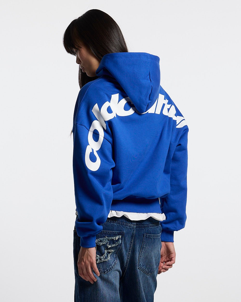 CURVED HOODIE BLUE - royal blue logo print hoodie, back view on female model - Cold Culture #woman