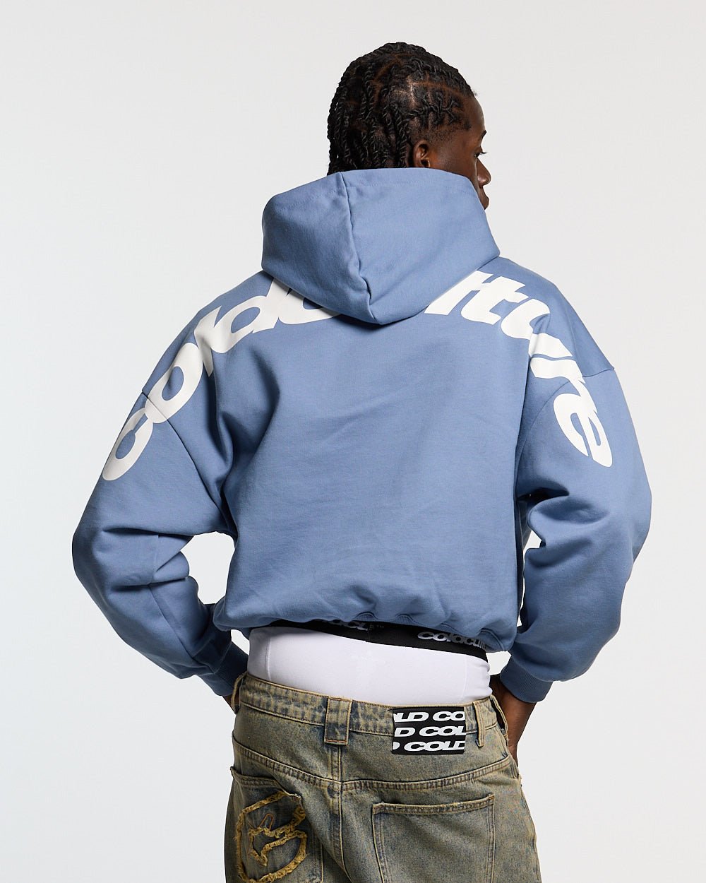 CURVED HOODIE LIGHT BLUE - light blue oversized hoodie, back view on male model - Cold Culture