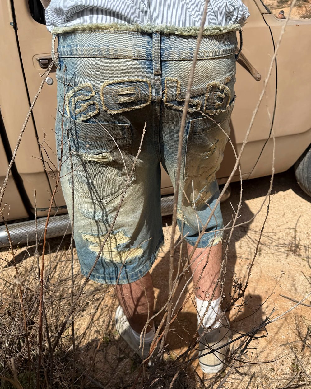 DISRUPT SHORTS LIGHT BLUE - light blue distressed denim shorts, street style shot - Cold Culture