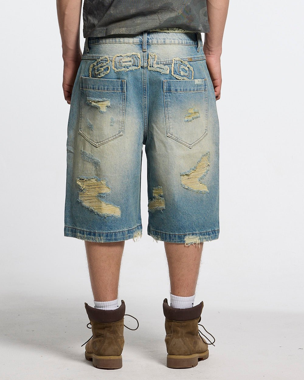 DISRUPT SHORTS LIGHT BLUE - light blue distressed denim shorts, back view on male model - Cold Culture