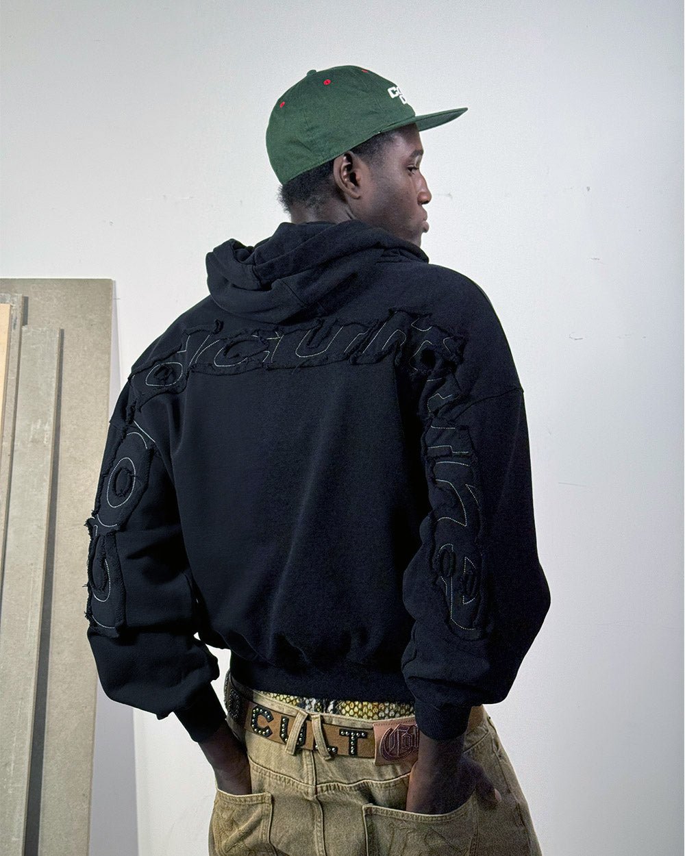 DISTRESS CURVED HOODIE BLACK - black distressed hoodie, back view on male model - Cold Culture