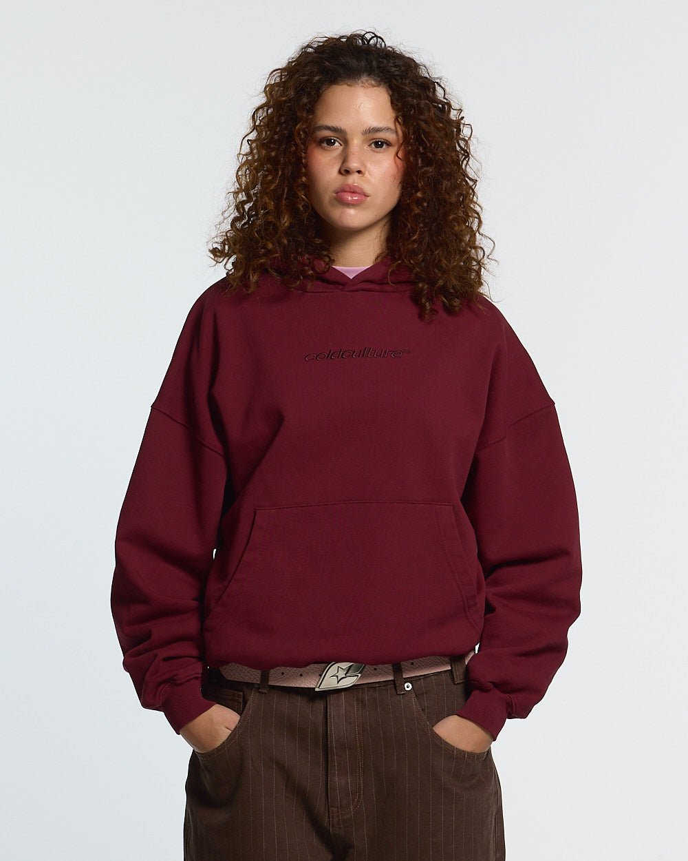 DISTRESS CURVED HOODIE BURGUNDY - burgundy distressed hoodie, front view on female model - Cold Culture #woman