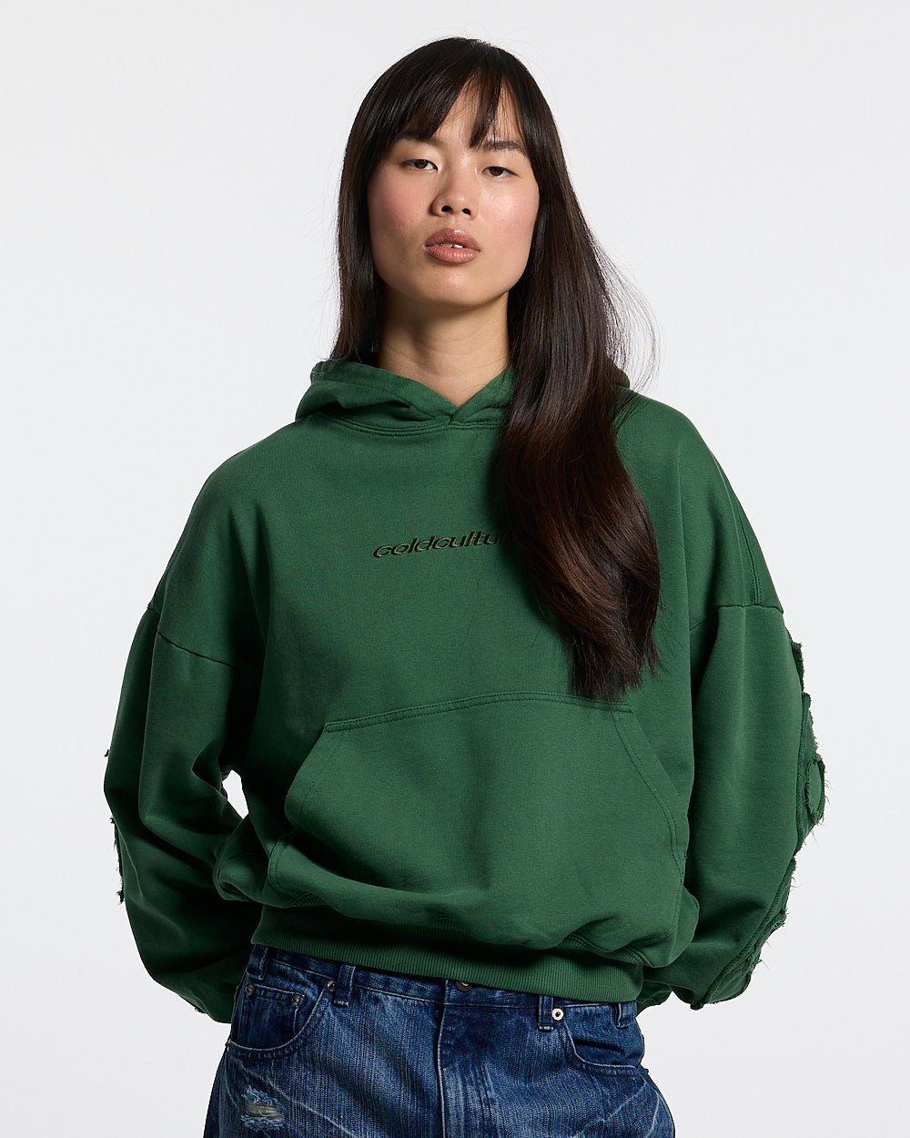 DISTRESS CURVED HOODIE GREEN - green distressed hoodie, front view on female model - Cold Culture #woman