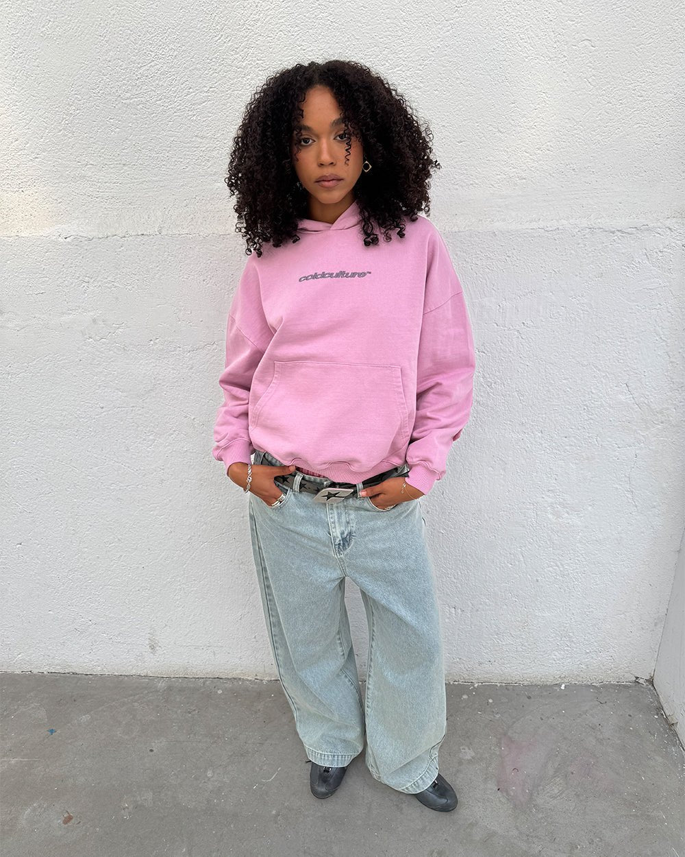DISTRESS CURVED HOODIE PINK - pink distressed hoodie, front view on female model - Cold Culture #woman