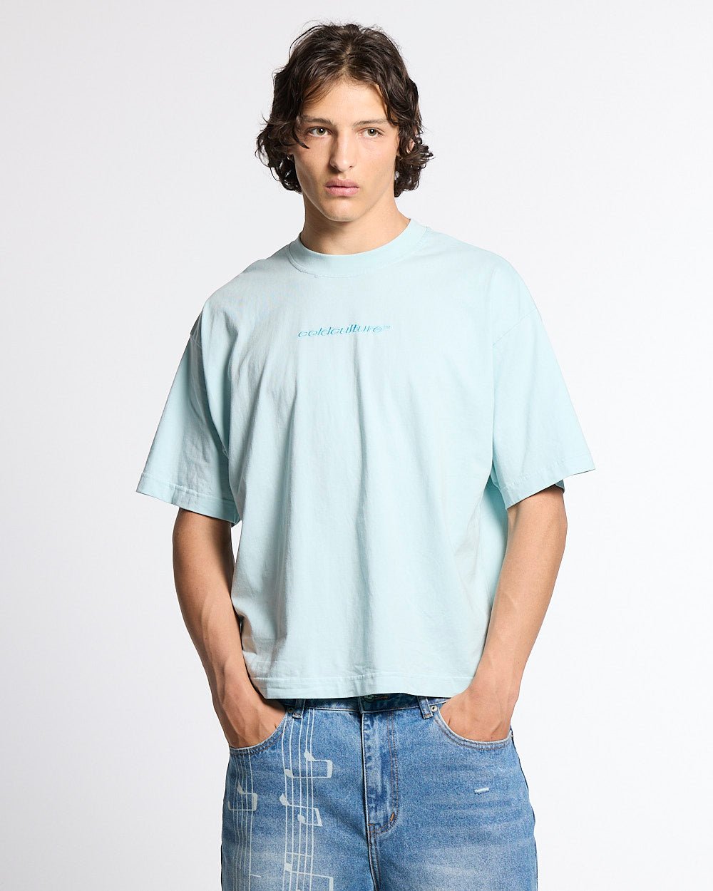 DISTRESS CURVED TEE BLUE - light blue distressed logo tee, front view on male model - Cold Culture #man