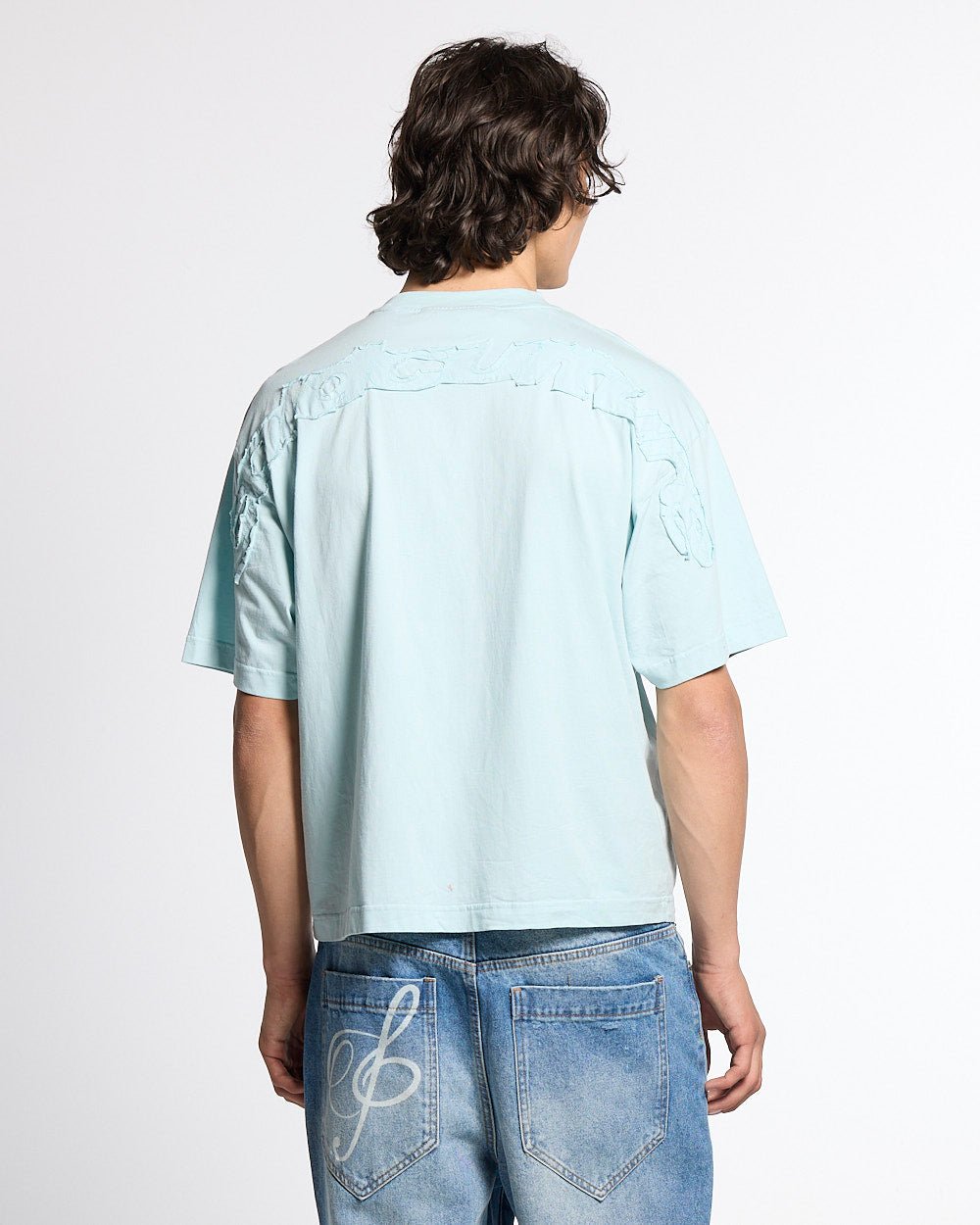 DISTRESS CURVED TEE BLUE - light blue distressed logo tee, back view on male model - Cold Culture #man