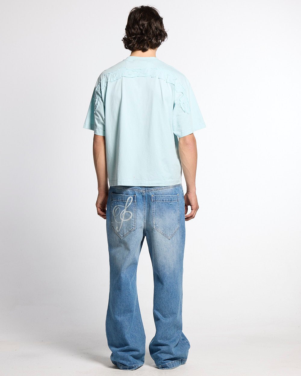 DISTRESS CURVED TEE BLUE - light blue distressed logo tee, back view on male model - Cold Culture #man