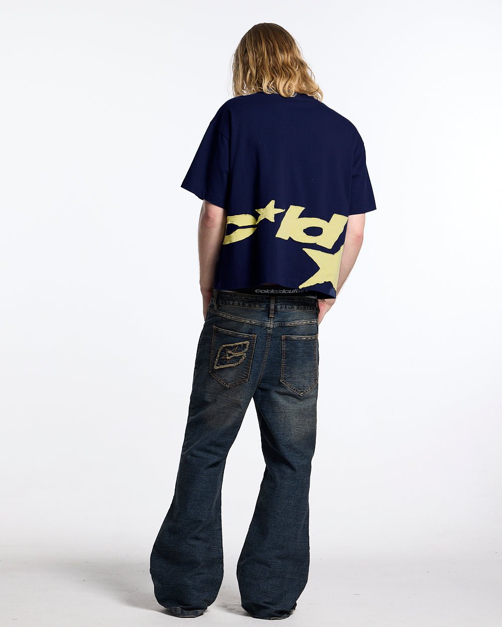 DISTRESS DEFENSE TEE NAVY - navy blue graphic print tee, back view on male model - Cold Culture #man
