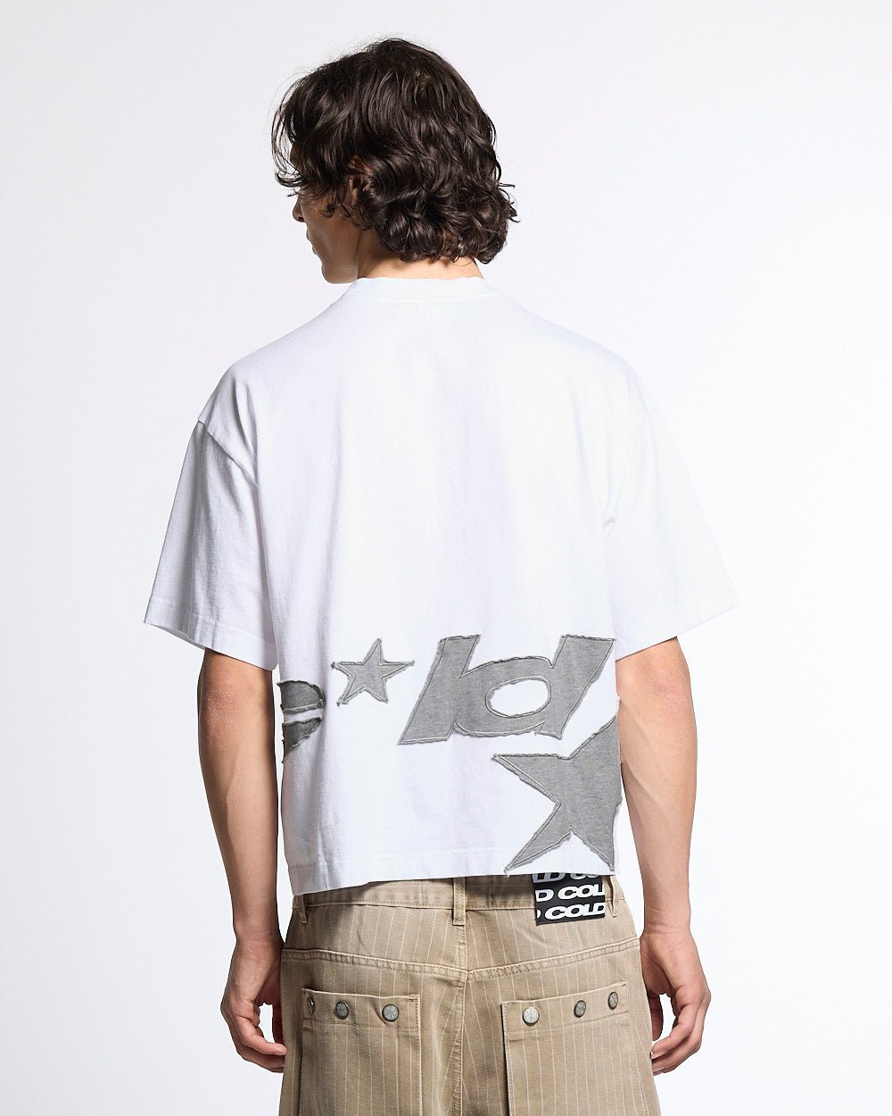 DISTRESS DEFENSE TEE WHITE - white graphic print tee, back view on male model - Cold Culture #man