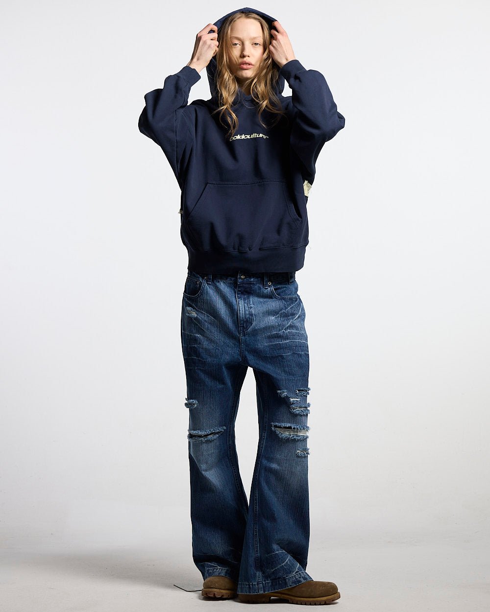 DISTRESSED DEFENSE HOODIE NAVY - navy distressed hoodie, front view on female model - Cold Culture #woman