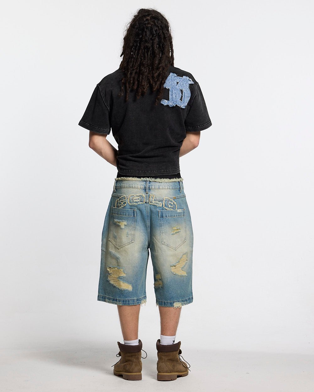 DISTRESSED DOLLAR POLO BLACK - black polo with denim applique, back view on male model - Cold Culture #man