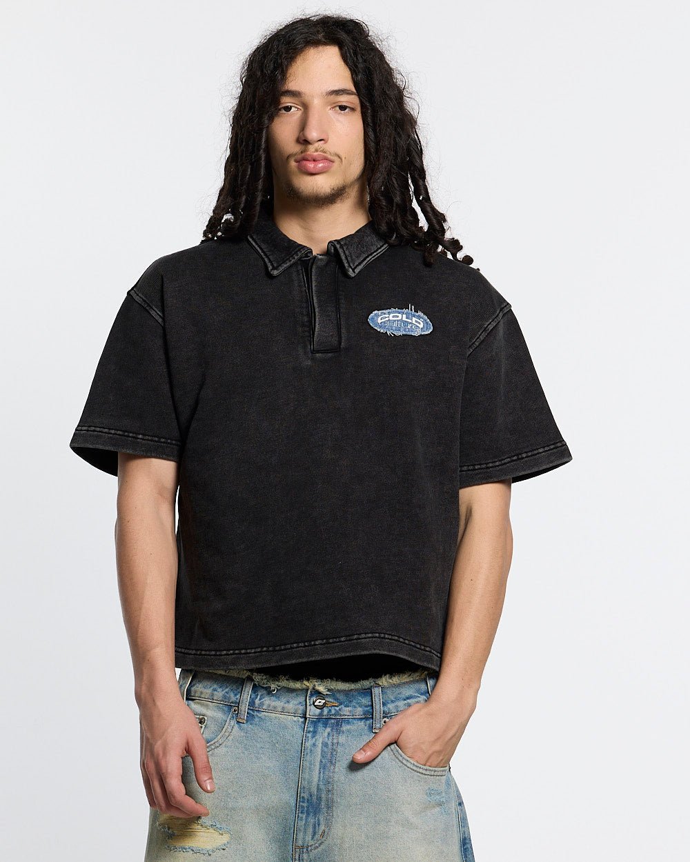 DISTRESSED DOLLAR POLO BLACK - black polo with denim applique, front view on male model - Cold Culture #man