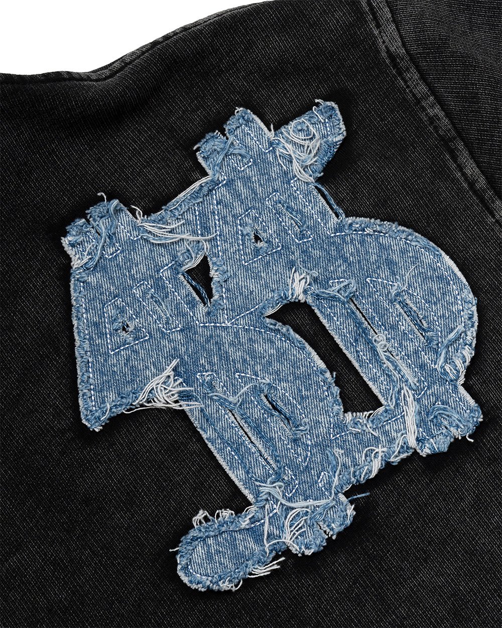 DISTRESSED DOLLAR POLO BLACK - black polo with denim applique, detail close-up - Cold Culture