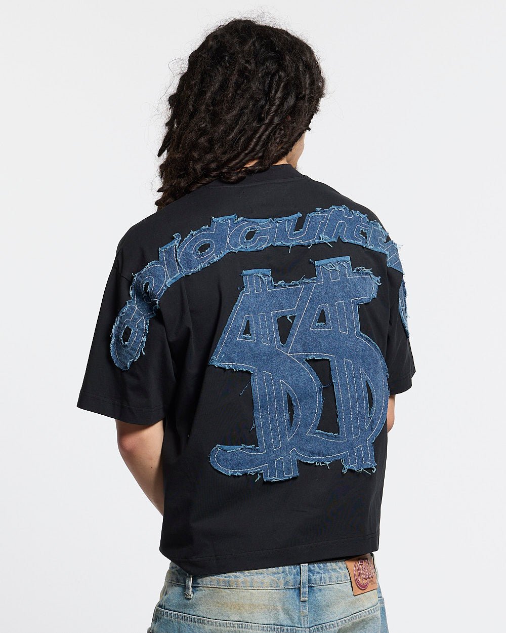 DISTRESSED DOLLAR TEE BLACK - black tee with denim applique, back view on male model - Cold Culture #man