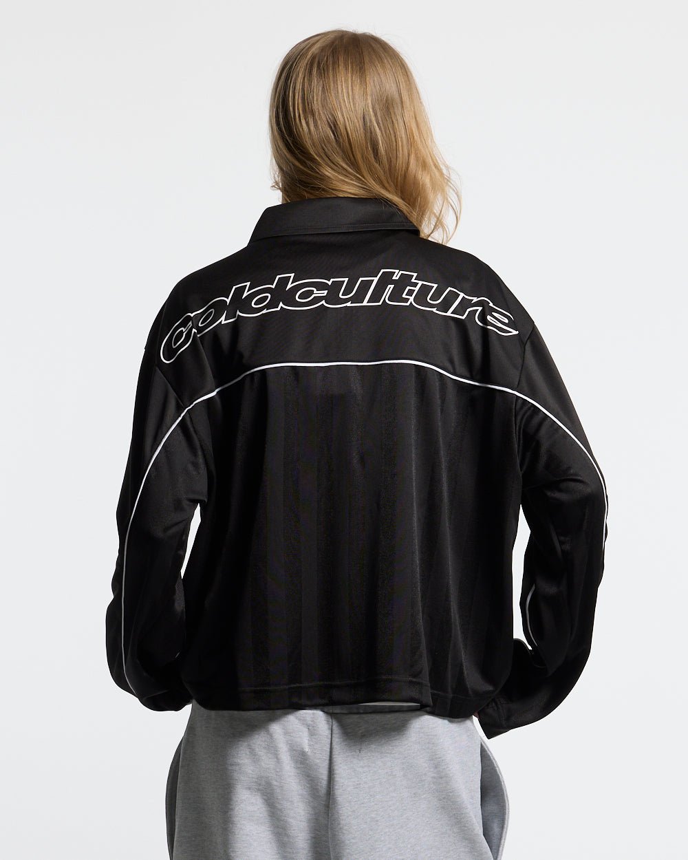 DRAW THE LINE LONGSLEEVE SHIRT BLACK - black zip track jacket, back view on female model - Cold Culture #woman