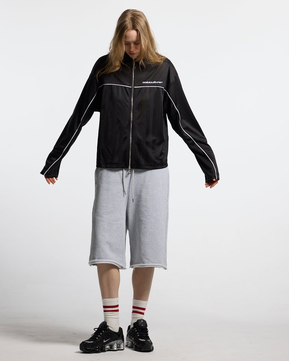 DRAW THE LINE LONGSLEEVE SHIRT BLACK - black zip track jacket, front view on female model - Cold Culture #woman