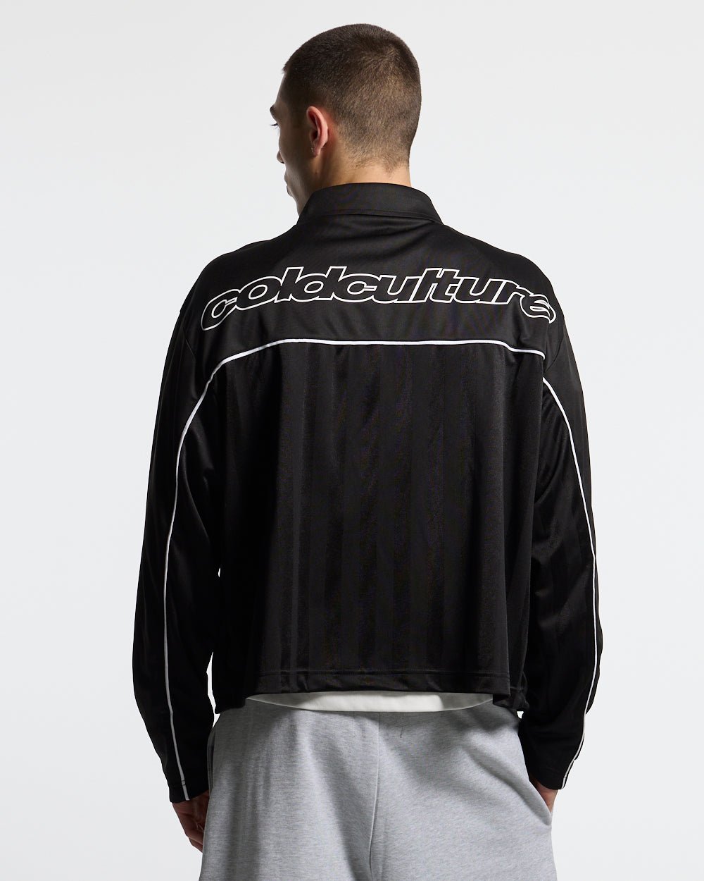 DRAW THE LINE LONGSLEEVE SHIRT BLACK - black zip track jacket, back view on male model - Cold Culture #man