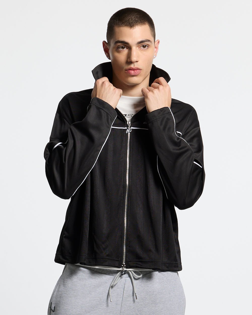 DRAW THE LINE LONGSLEEVE SHIRT BLACK - black zip track jacket, front view on male model - Cold Culture #man