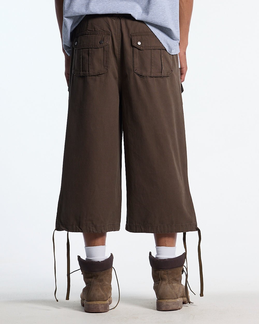 DUNE CAPRI PANTS BROWN - brown cargo capri pants, back view on male model - Cold Culture