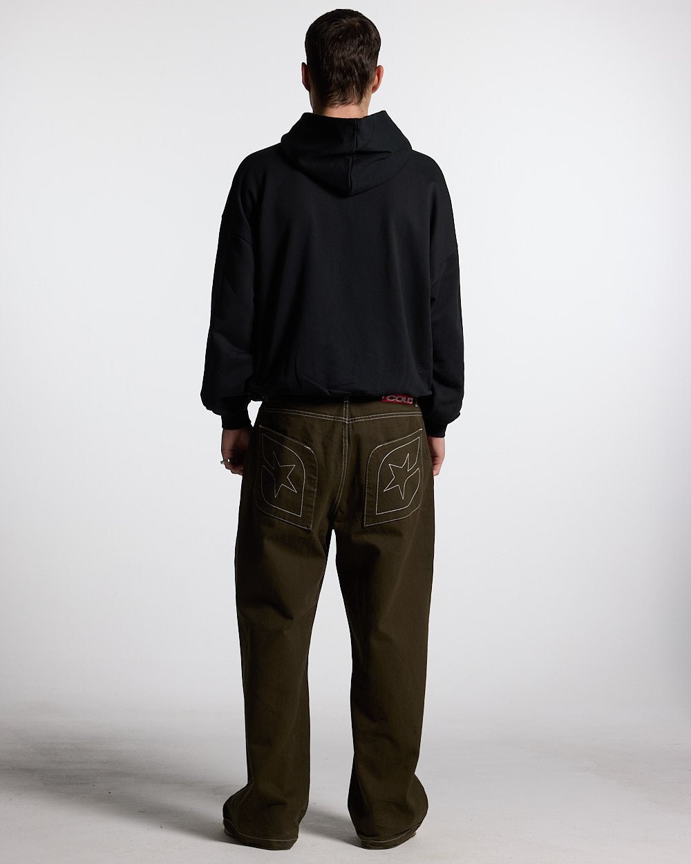 ESSENTIAL HOODIE BLACK - black oversized hoodie, back view on male model - Cold Culture