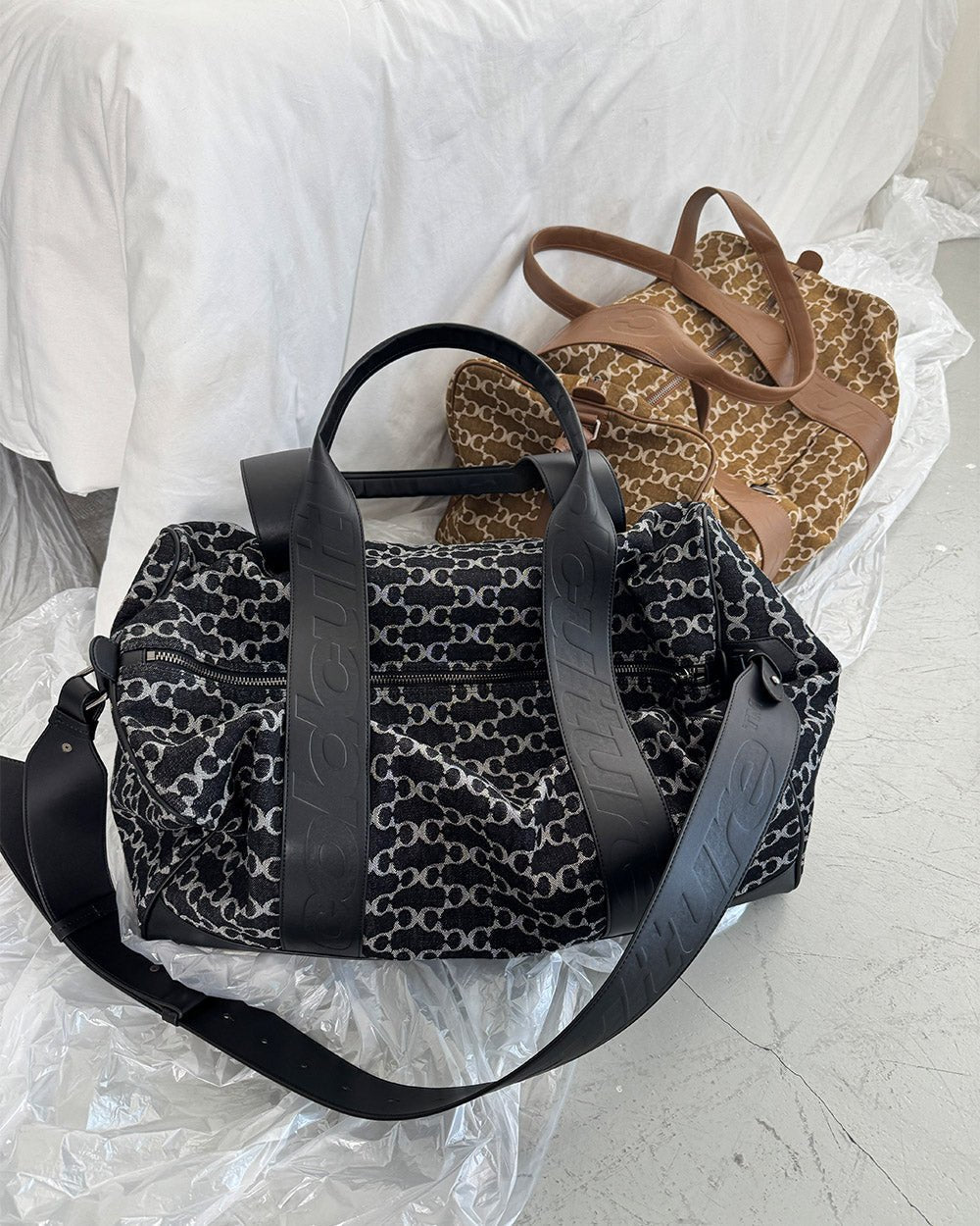FEVER BAG BLACK - black monogram duffle bag, flat lay with matching pieces - Cold Culture