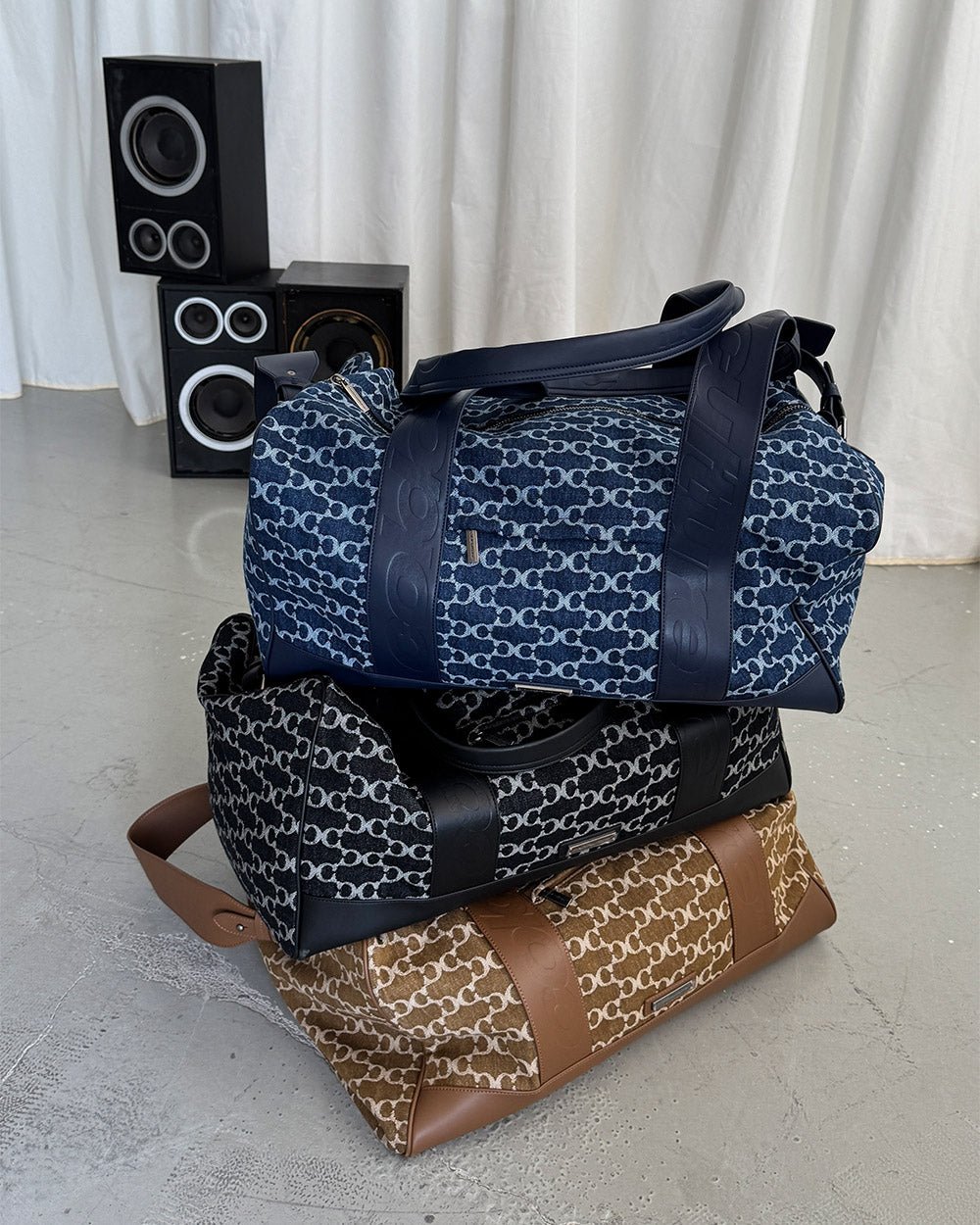 FEVER BAG BLACK - black monogram duffle bag, flat lay with matching pieces - Cold Culture