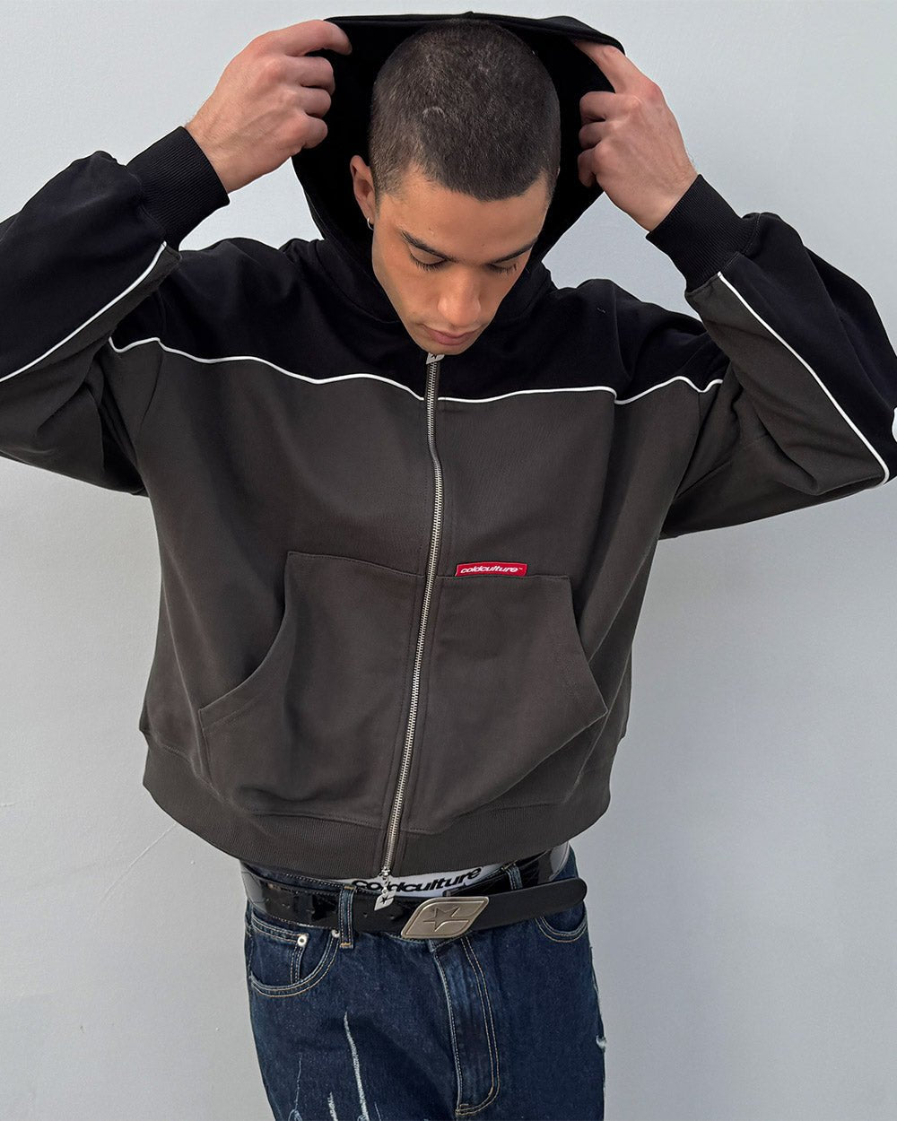 FLESH ZIP HOODIE BLACK & GREY - black and grey zip-up hoodie, front view on male model - Cold Culture #man