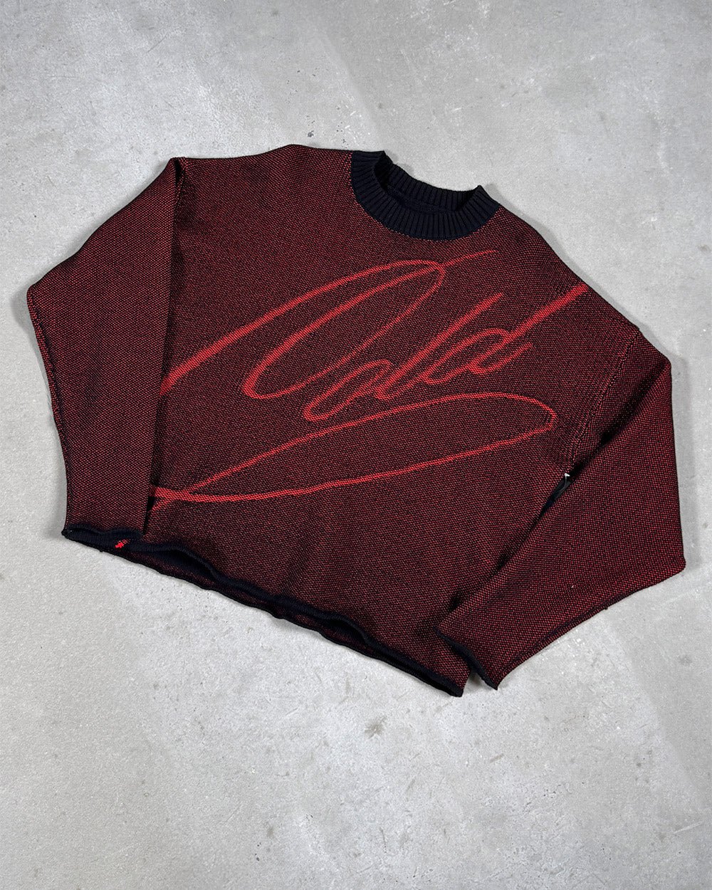 GRUBBY KNIT BLACK - black and red script knit sweater, flat lay - Cold Culture