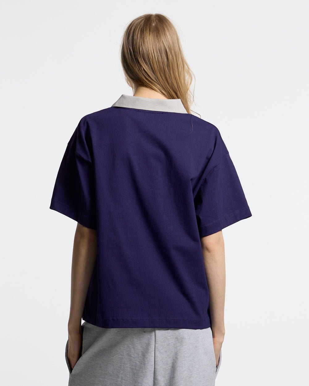 HEAT GYM POLO NAVY - navy zip polo shirt, back view on female model - Cold Culture #woman