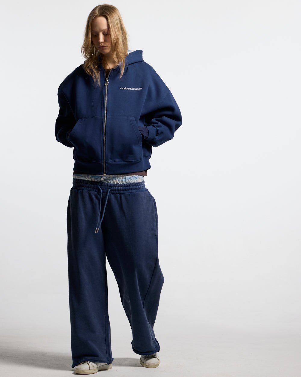 HIDE AND SEEK ZIP HOODIE NAVY - navy zip-up hoodie, front view on female model - Cold Culture #woman