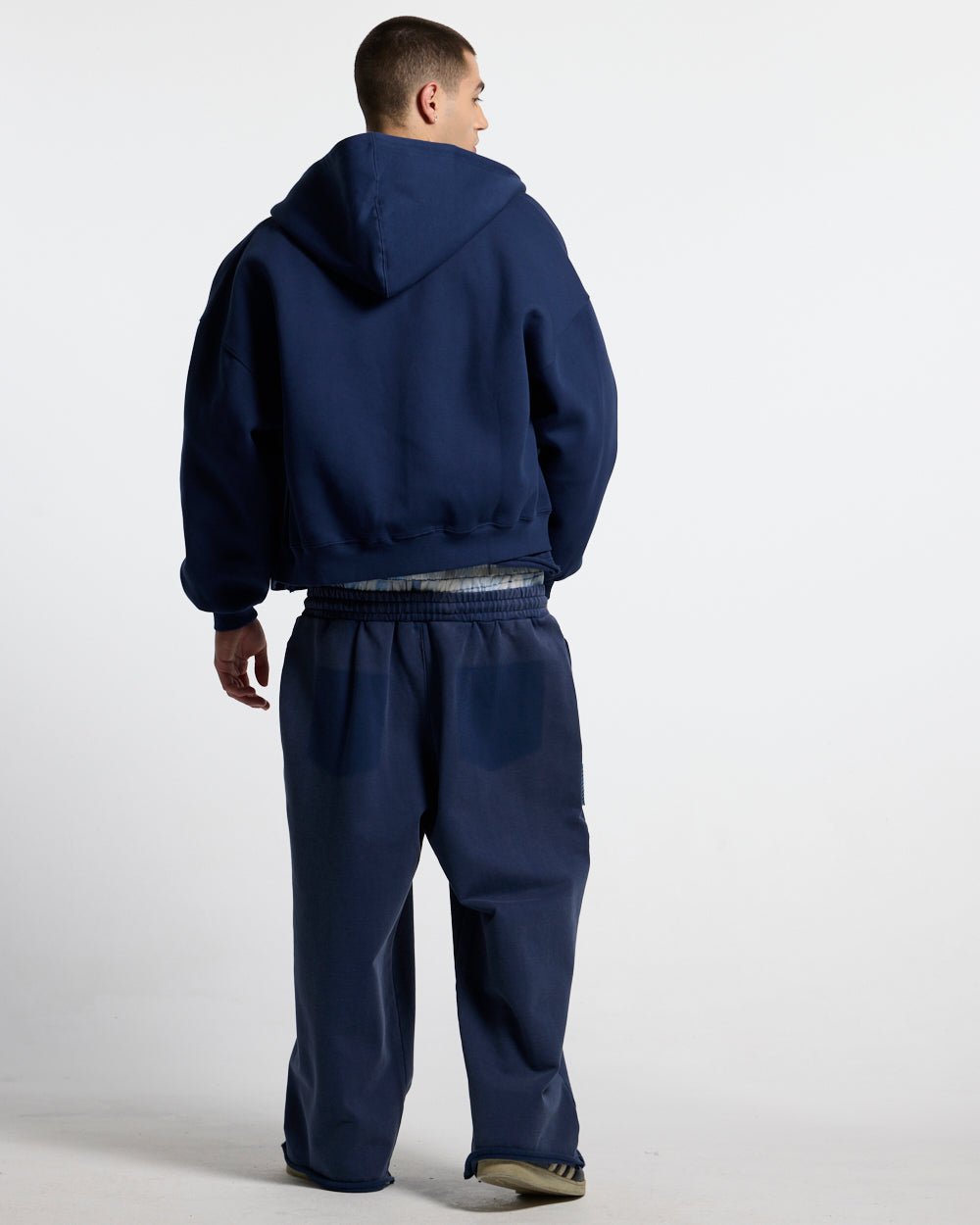 HIDE AND SEEK ZIP HOODIE NAVY - navy zip-up hoodie, back view on male model - Cold Culture
