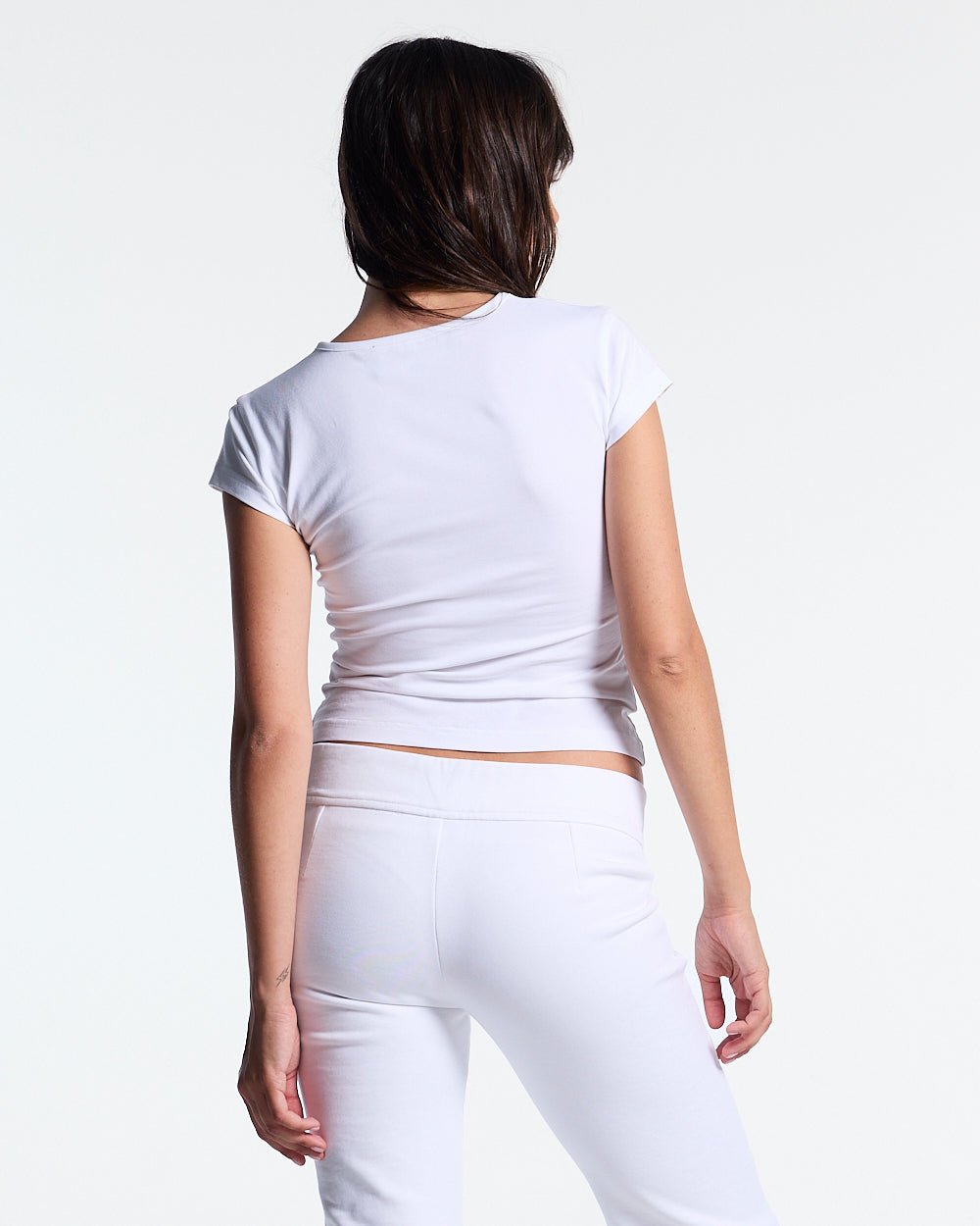 ICON BABY TEE WHITE - white graphic print women's tee, back view on female model - Cold Culture #woman