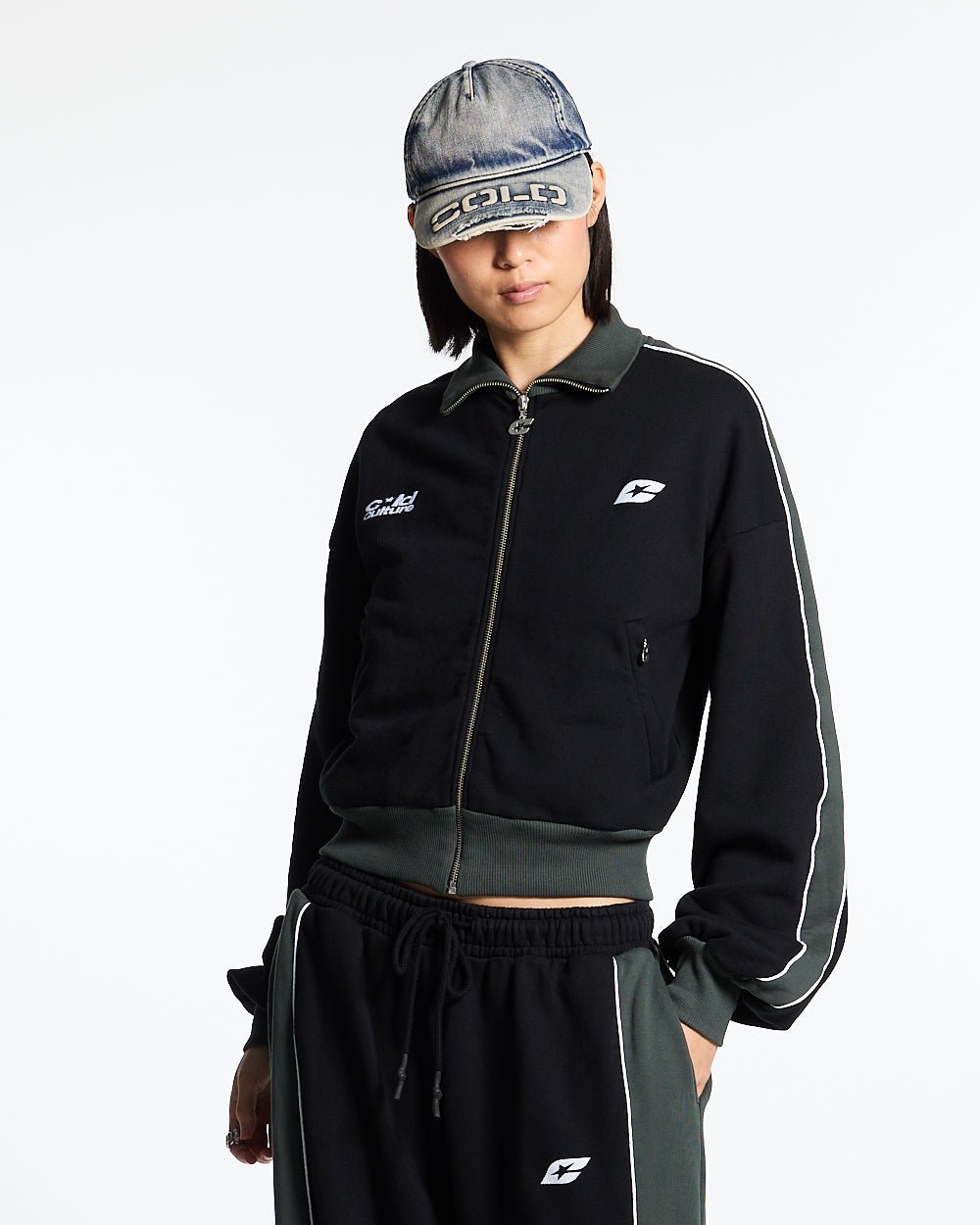 JET LAG JACKET BLACK - black and green zip-up hoodie, front view on female model - Cold Culture #woman