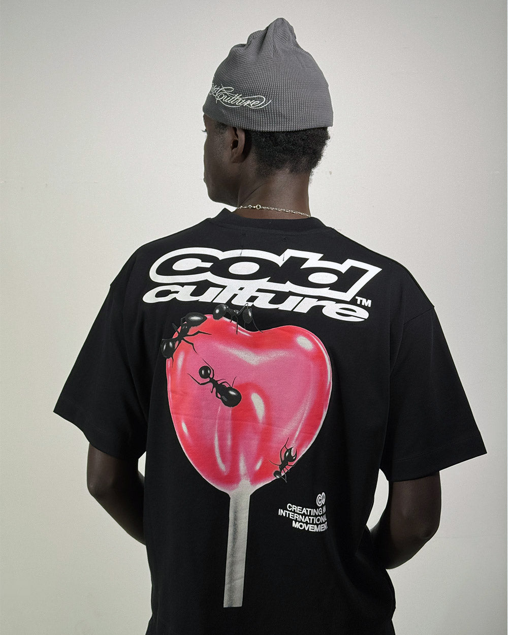 LOLLIPOP TEE BLACK - black graphic print tee, back view on male model - Cold Culture #man