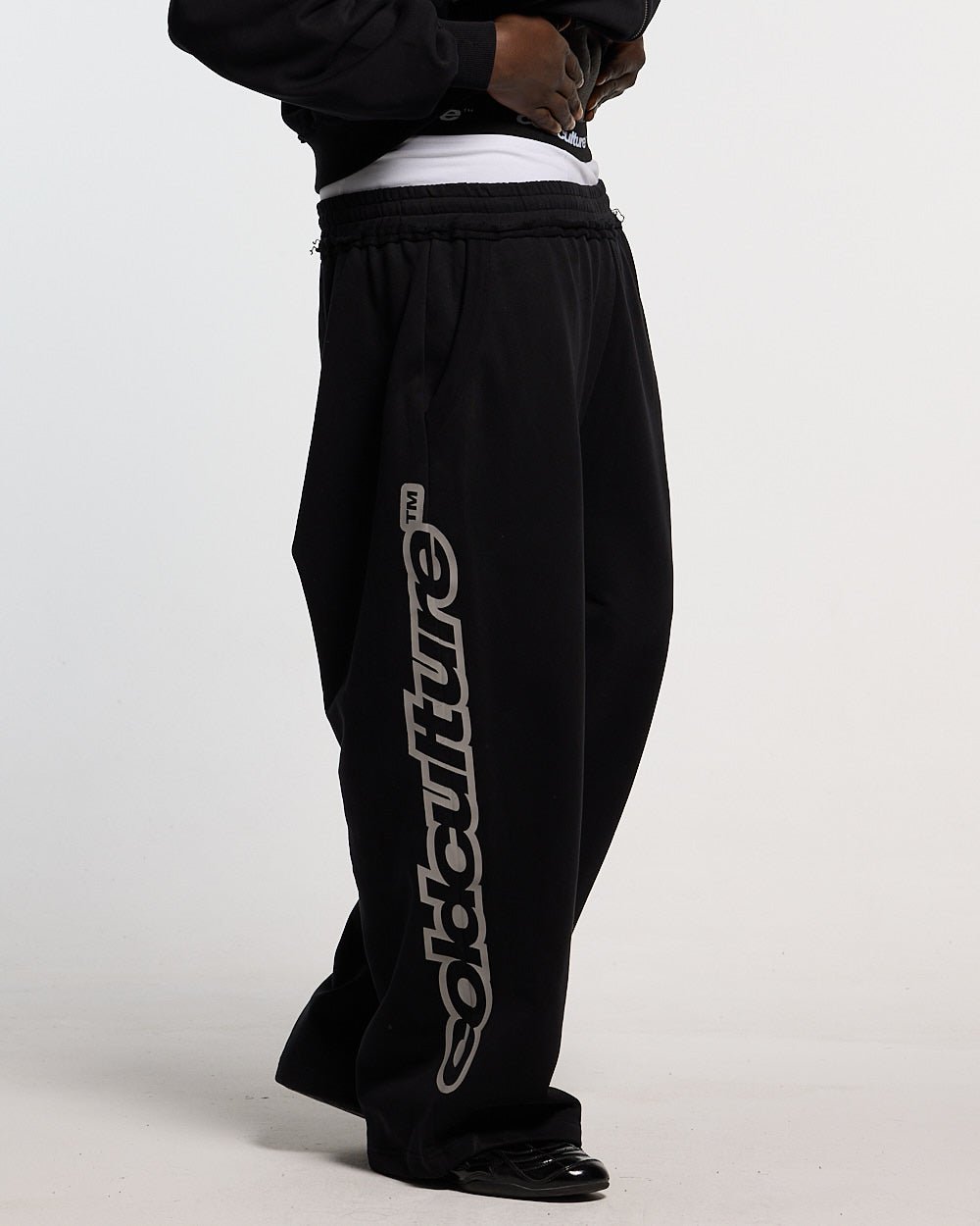 MIDNIGHT SET SWEATPANT BLACK - black logo print sweatpants, side view - Cold Culture