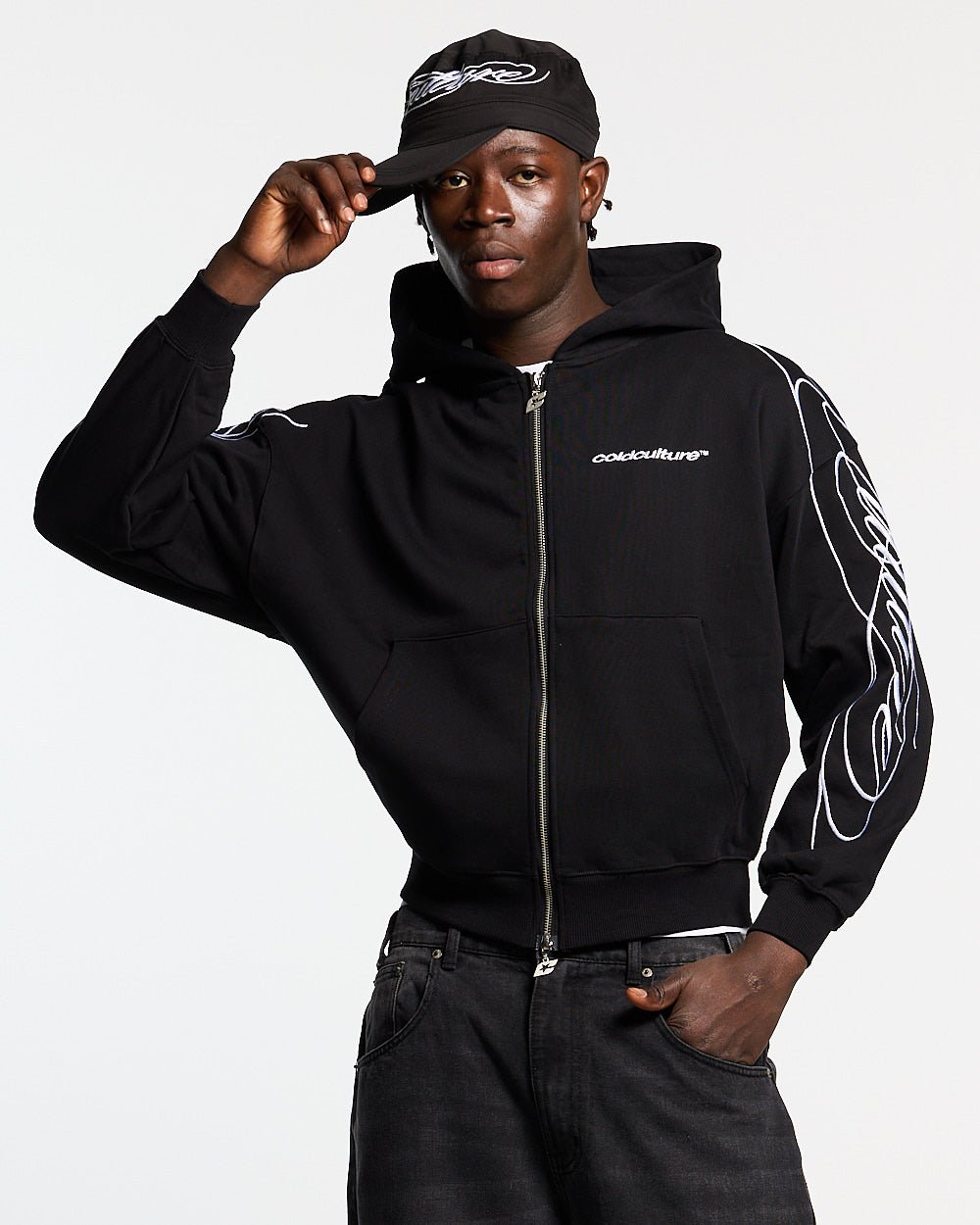 NEW SCRIPT ZIP HOODIE BLACK - black embroidered zip-up hoodie, front view on male model - Cold Culture #man