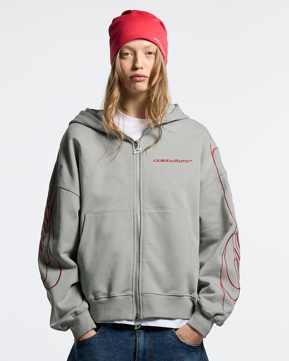 NEW SCRIPT ZIP HOODIE GREY & RED - grey zip-up hoodie, front view on female model - Cold Culture #woman