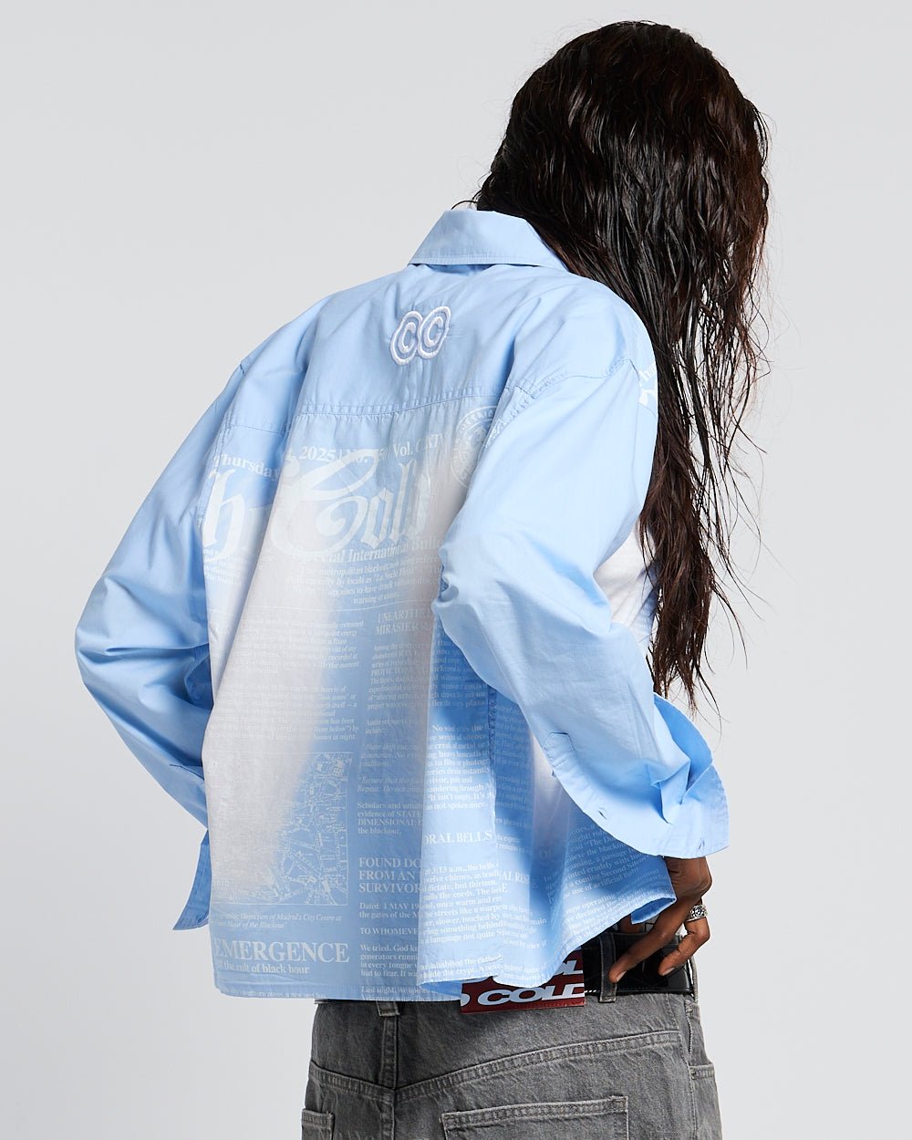 NEWSPAPER LONGSLEEVE SHIRT BABY BLUE - baby blue newspaper print shirt, back view on female model - Cold Culture #woman