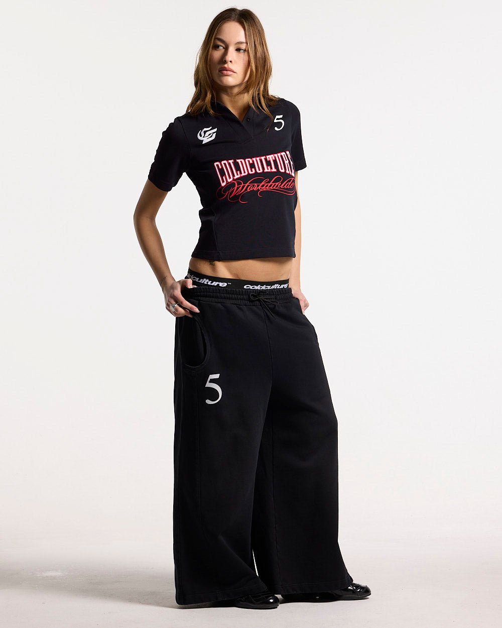 NIA SET POLO BLACK - black graphic print polo shirt, front view on female model - Cold Culture #woman