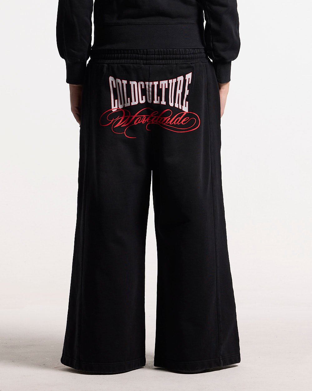 NIA SET SWEATPANTS BLACK - black wide-leg sweatpants, back view on female model - Cold Culture #woman