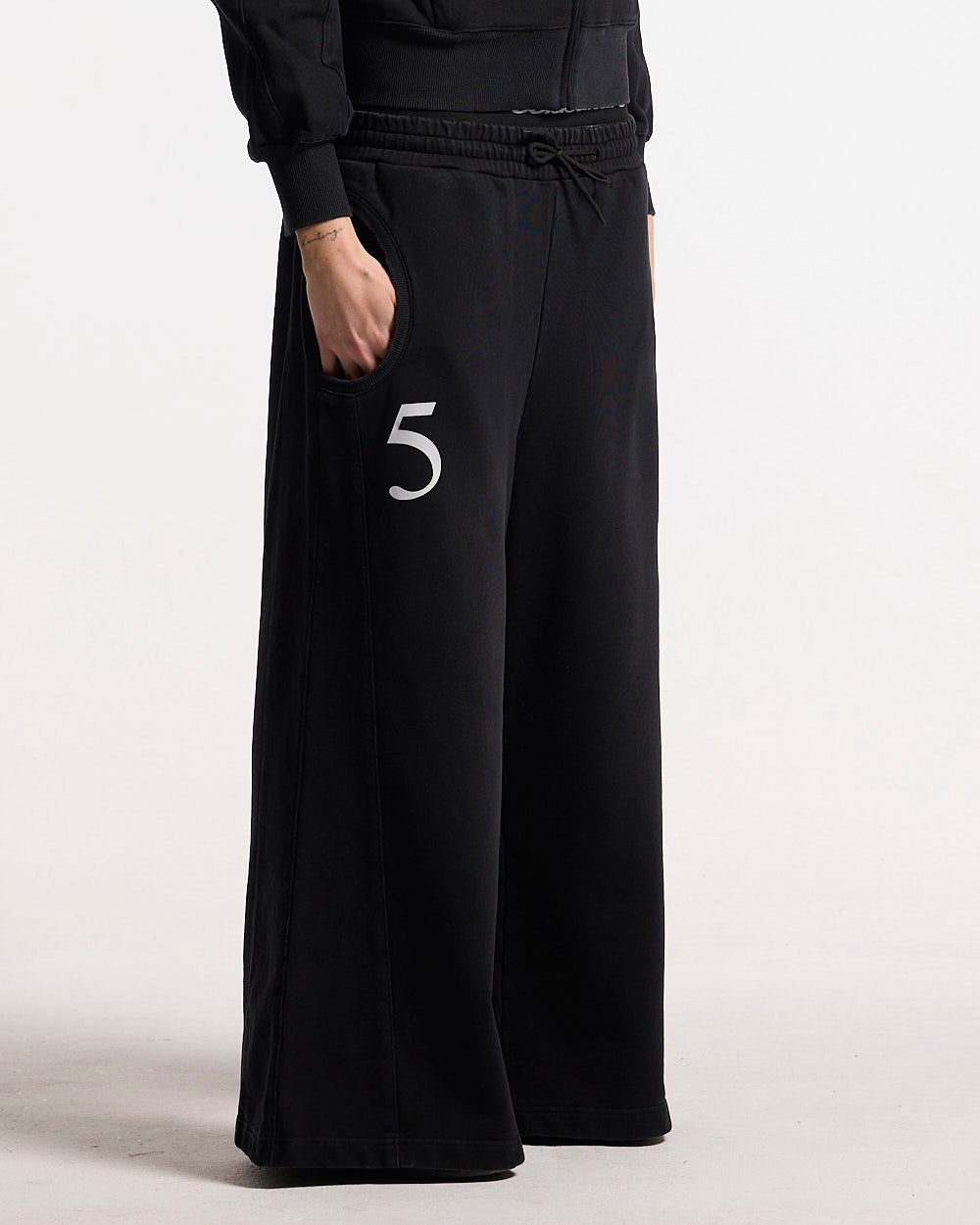 NIA SET SWEATPANTS BLACK - black wide-leg sweatpants, front view on female model - Cold Culture #woman