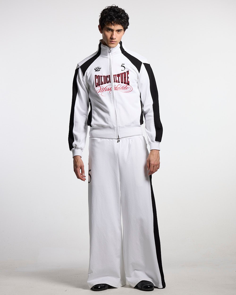 NIA SET SWEATPANTS WHITE & BLACK - white and black wide-leg sweatpants, front view on male model - Cold Culture #man