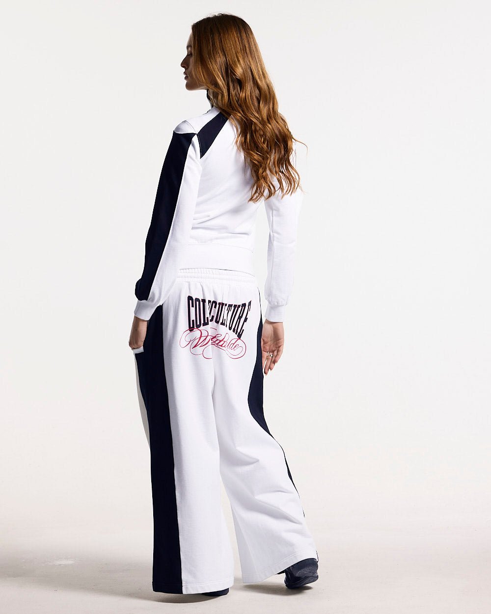 NIA SET SWEATPANTS WHITE & BLACK - white and black wide-leg sweatpants, back view on female model - Cold Culture #woman