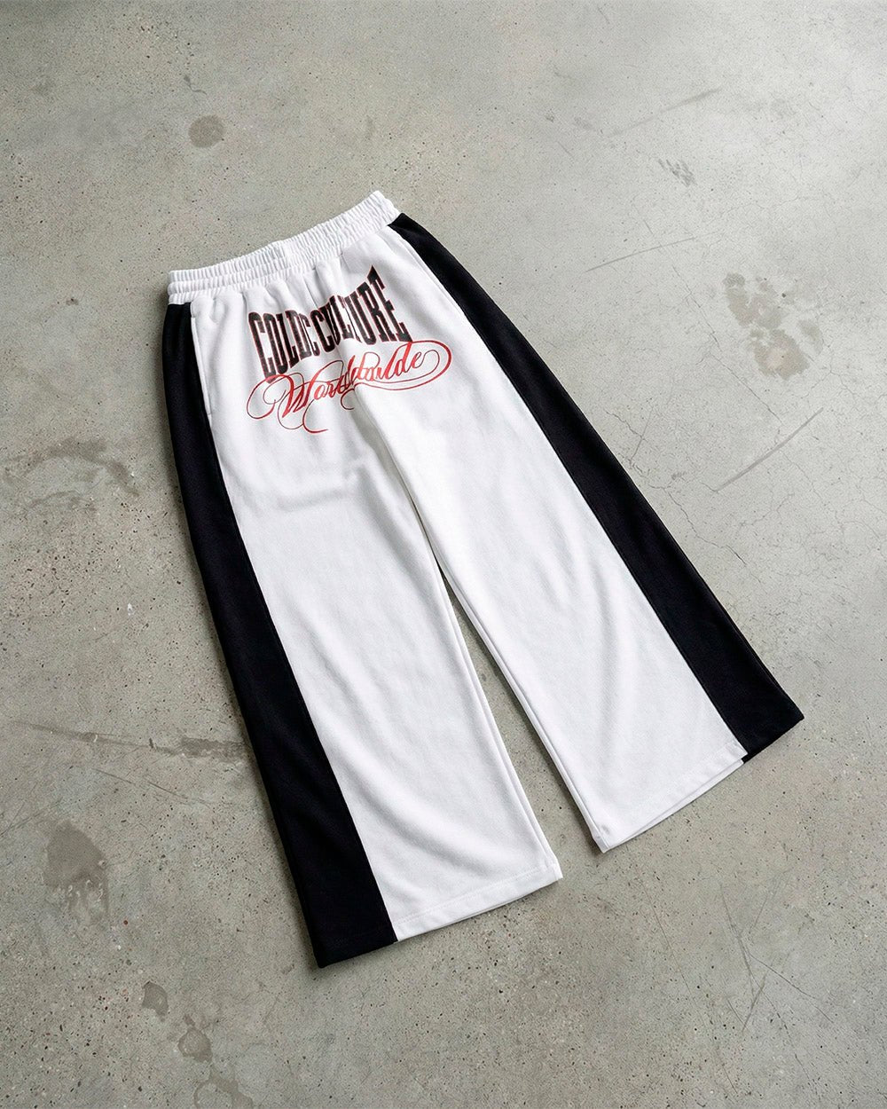 NIA SET SWEATPANTS WHITE & BLACK - white and black wide-leg sweatpants, flat lay - Cold Culture