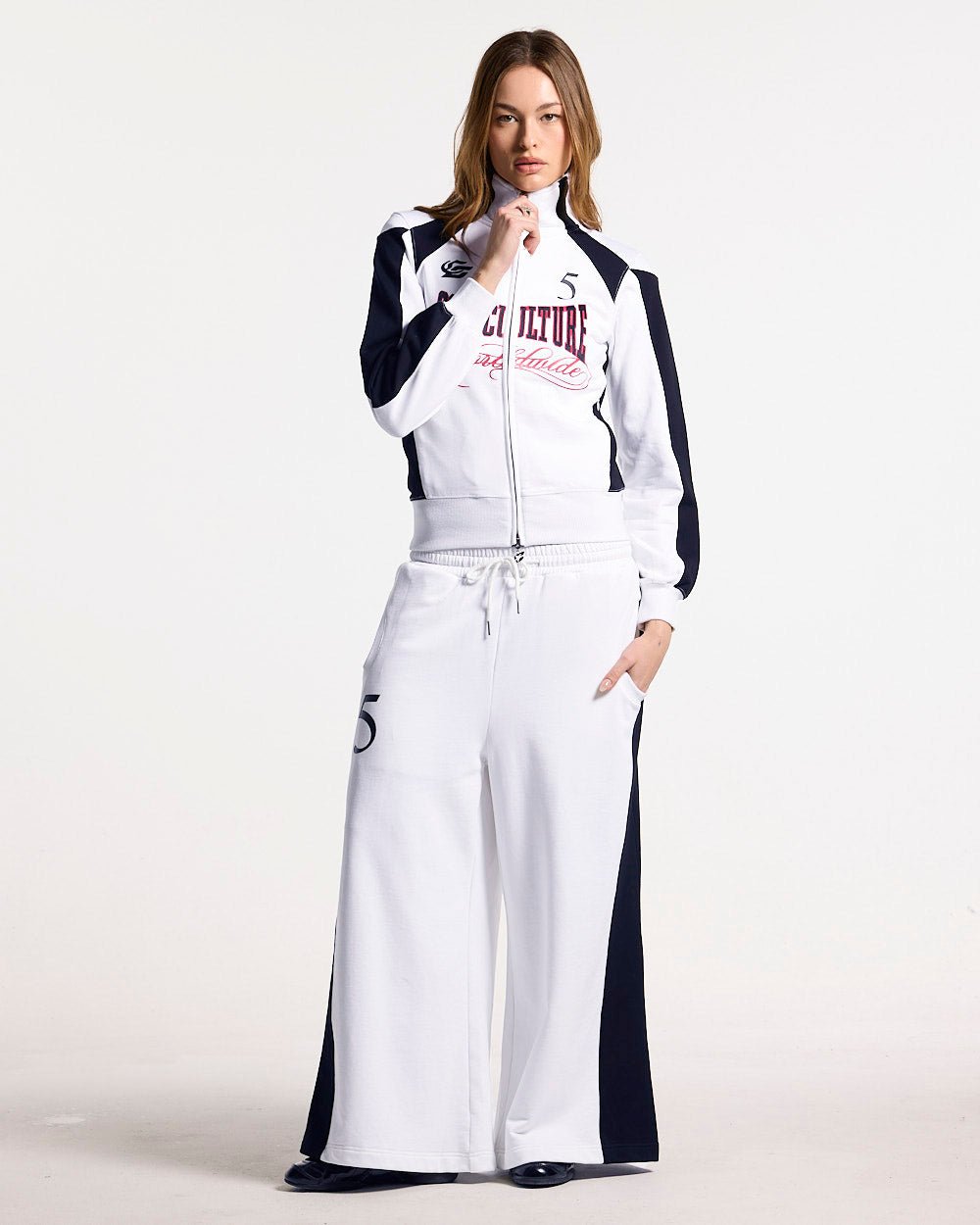 NIA SET SWEATPANTS WHITE & BLACK - white and black wide-leg sweatpants, front view on female model - Cold Culture #woman