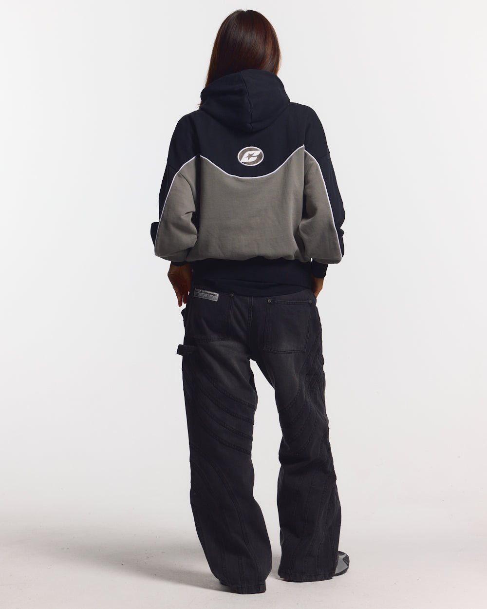NO RISK ZIP HOODIE BLACK - black and grey colorblock zip-up hoodie, back view on female model - Cold Culture #woman