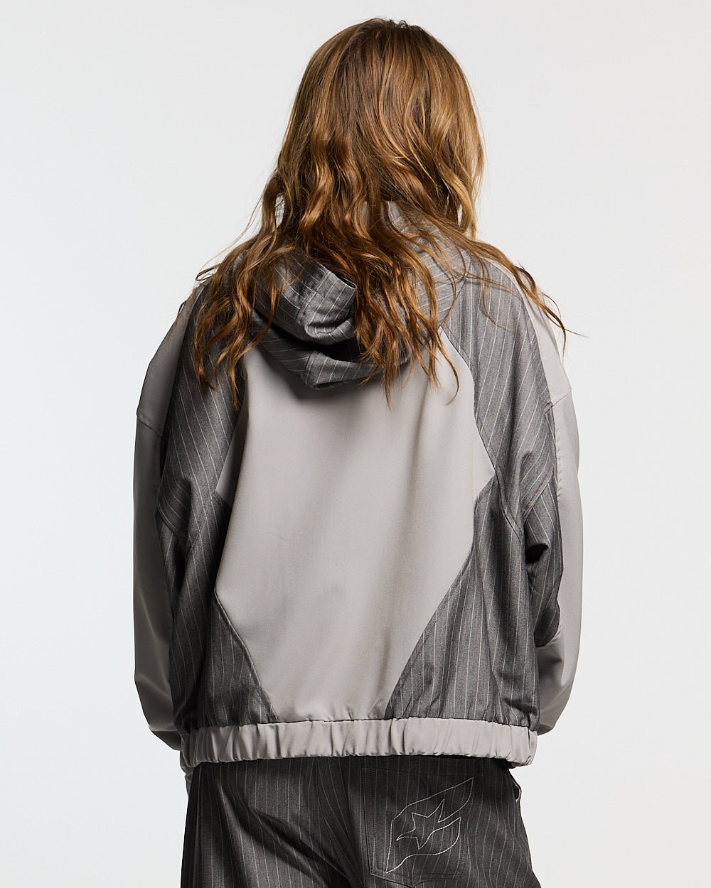NOT FORMAL SET JACKET GREY - grey pinstripe track jacket, back view on female model - Cold Culture #woman