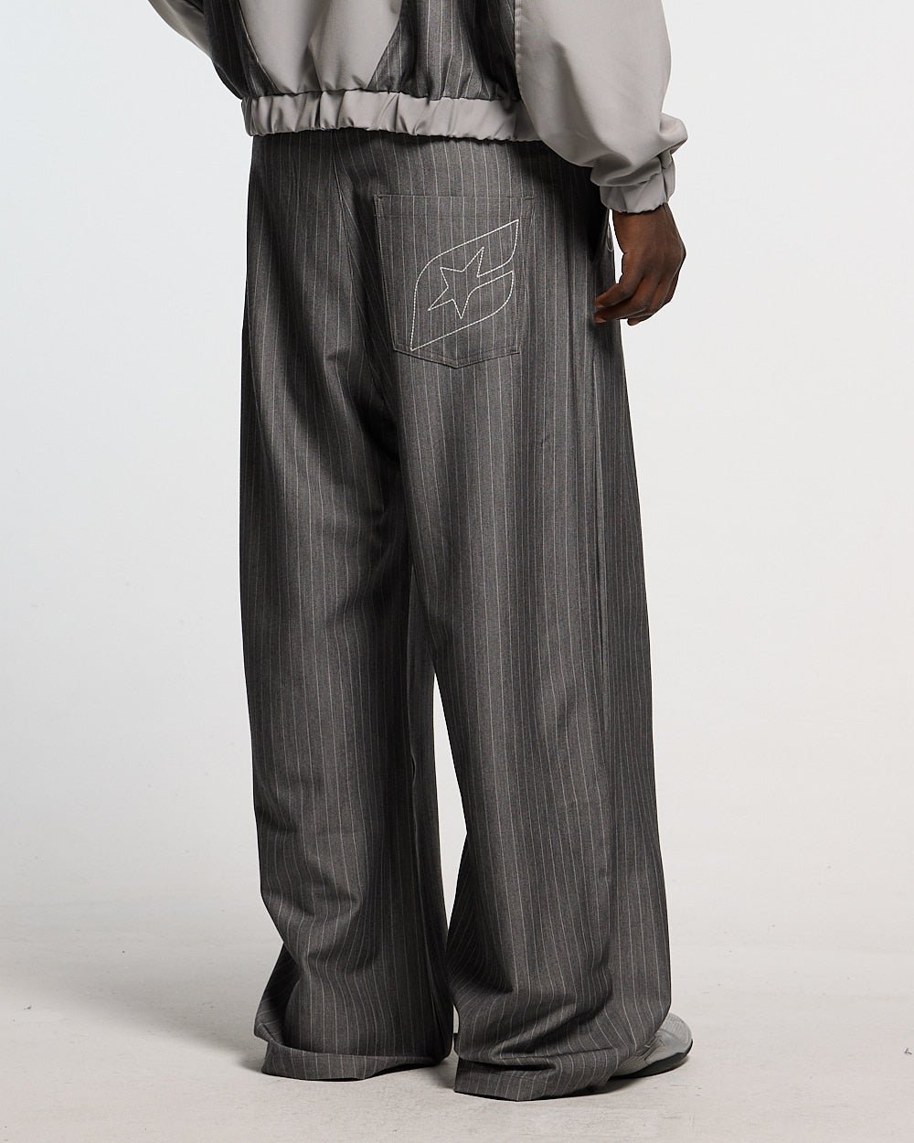 NOT FORMAL SET PANTS GREY - grey pinstripe pants, back view on male model - Cold Culture